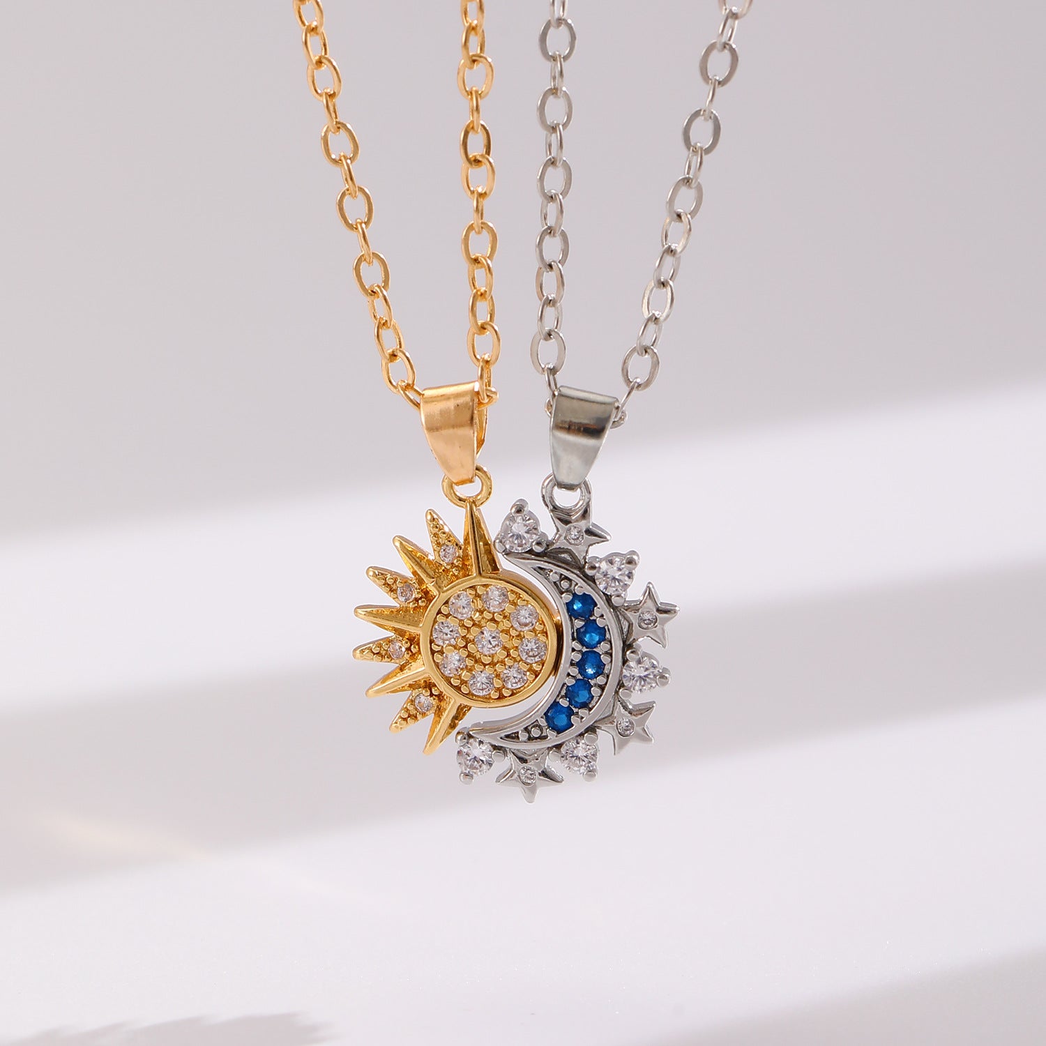 Two-tone gold sun and silver moon pendants joined