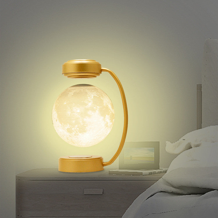 Gold La Lune glowing warm beside a bed