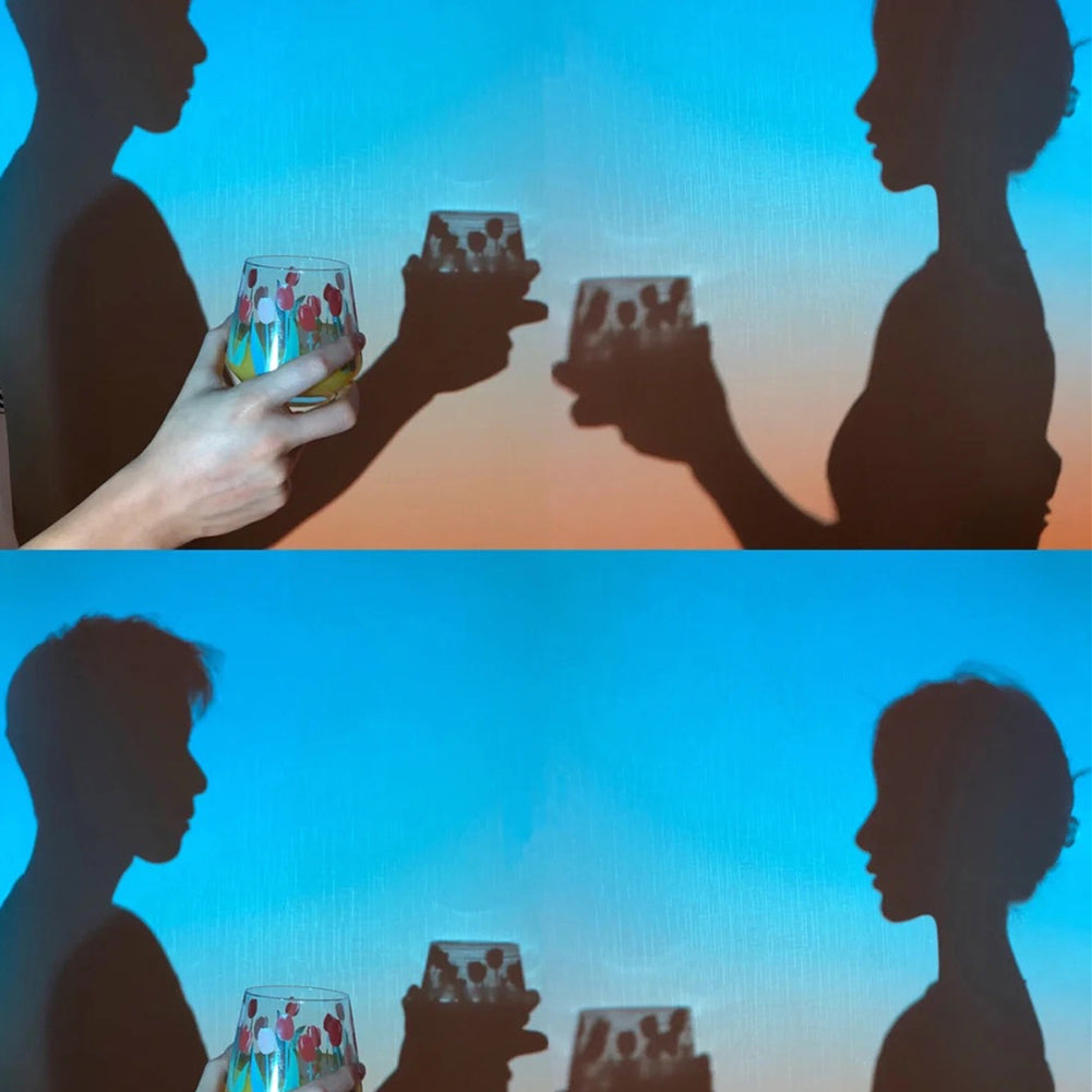 Couple silhouettes toasting in the sunset light