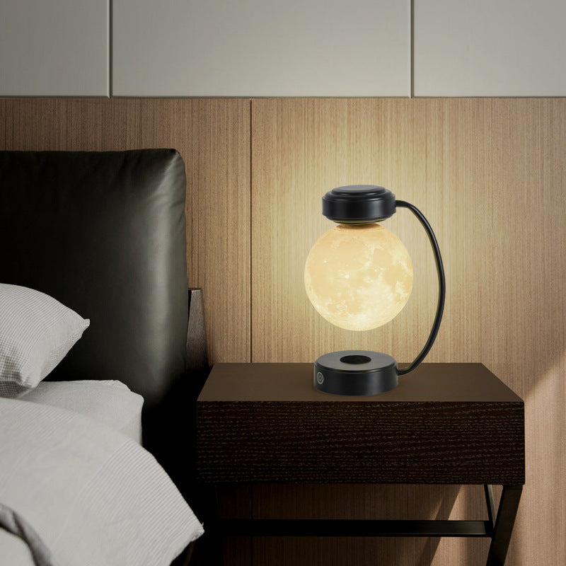 La Lune on a bedside table at night, black frame