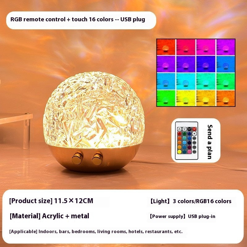 La Marée lamp lit in warm gold, with remote control and feature overview