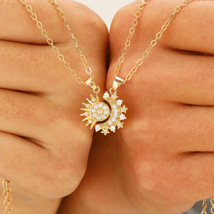 Hands holding the two Éclipse pendants about to click together
