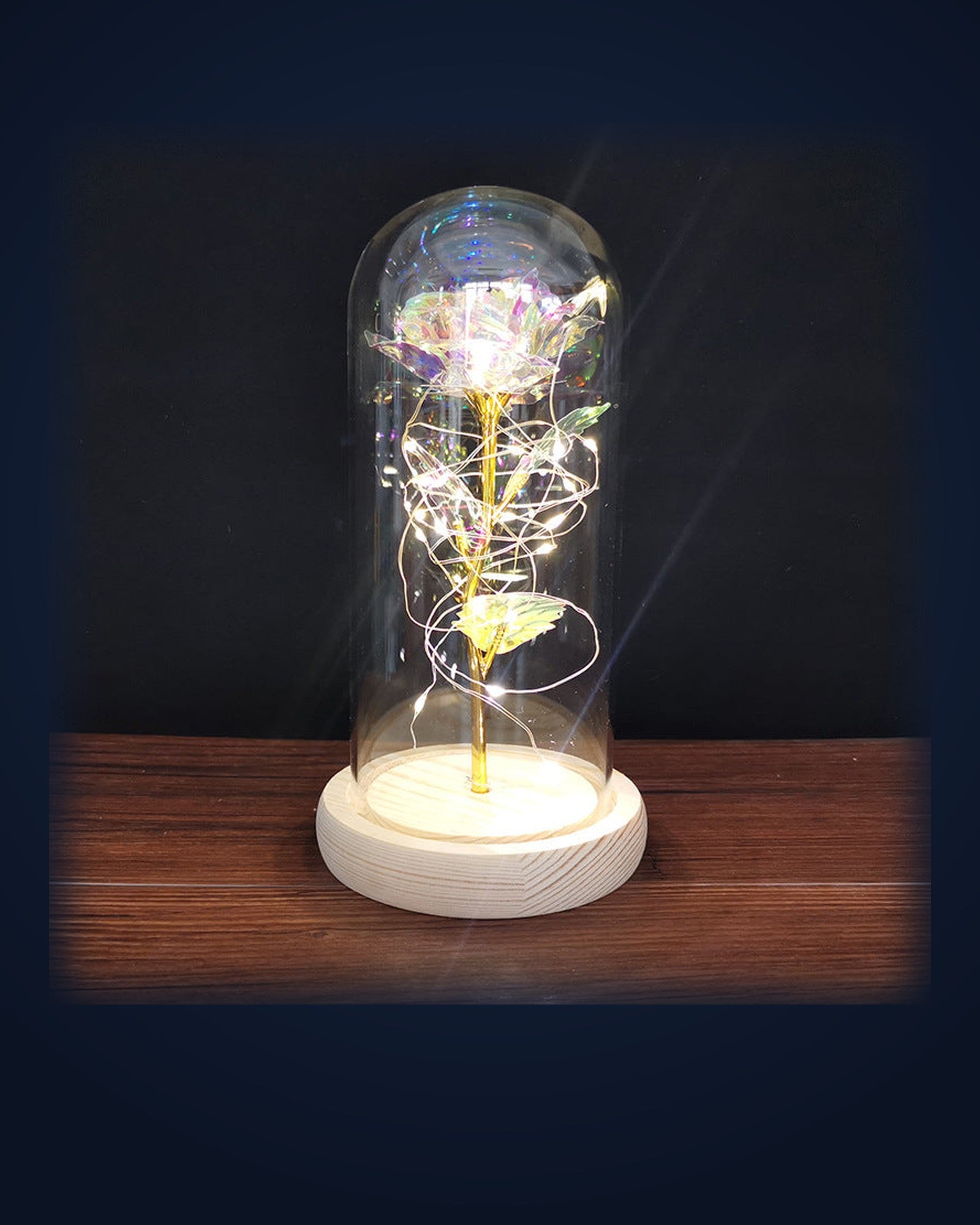 La Rose Éternelle glowing under its glass dome on navy